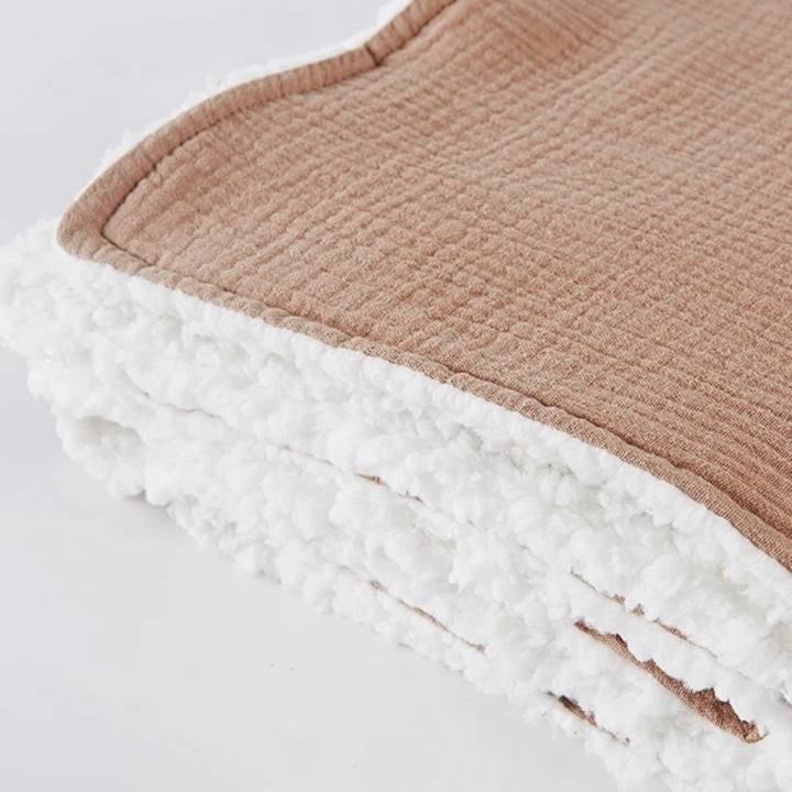 Brown baby blanket corner showing the textured front and fluffy white sherpa backing