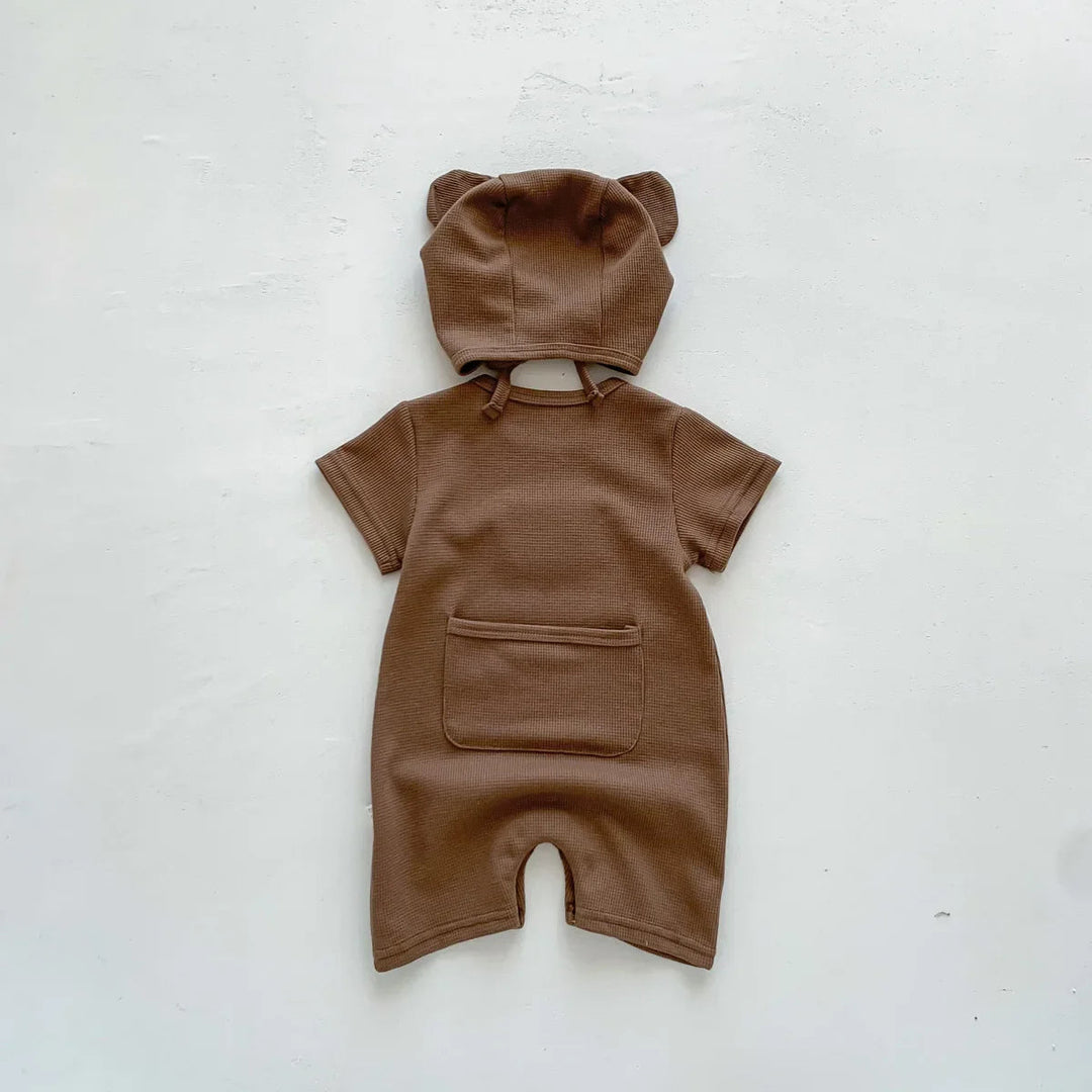 Back of brown baby romper with a patch pocket and matching ear-detail hat