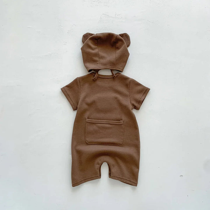 Back of brown baby romper with a patch pocket and matching ear-detail hat