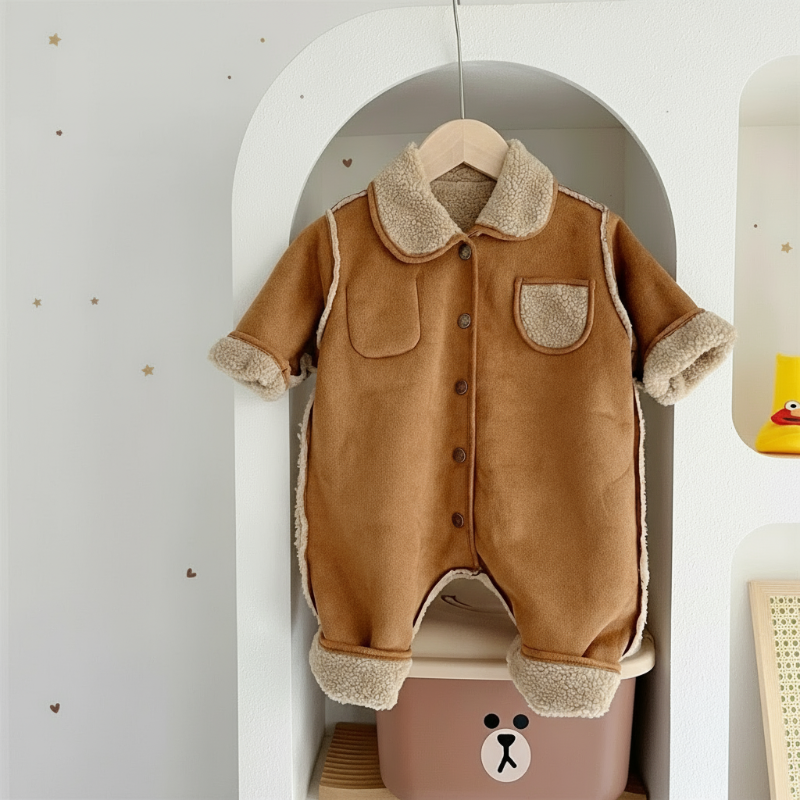 Brown collared baby romper with cream fleece trim, chest pockets, and front snaps