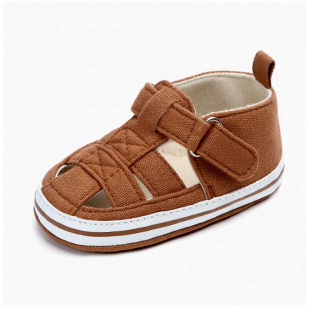 Brown baby sandal with quilted front detail, an ankle strap and white sole