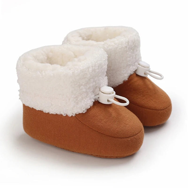 Brown baby winter boots with rounded toes and thick, fluffy white cuffs