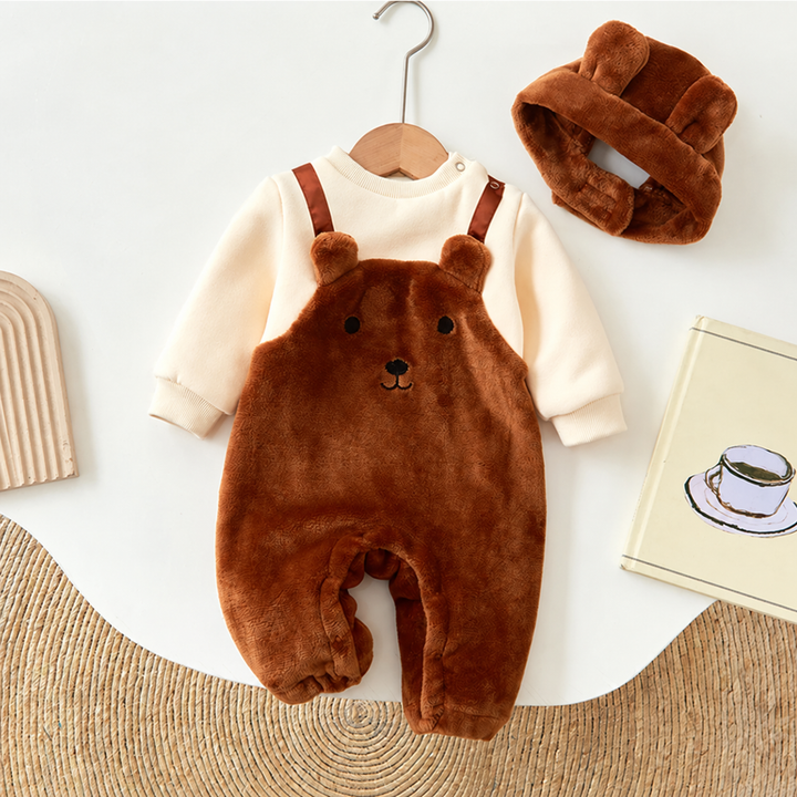 Brown bear romper with cream sleeves on a hanger beside its matching bear-ear hat