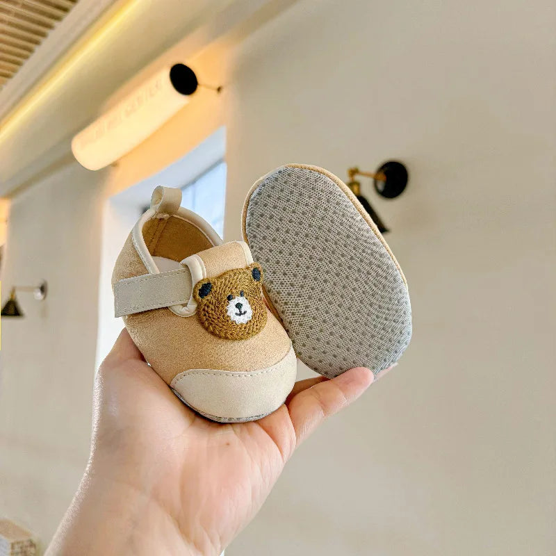 Brown bear baby shoes showing the animal detail and dotted sole