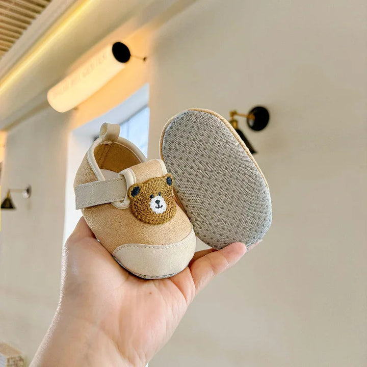 Brown bear baby shoes showing the animal detail and dotted sole