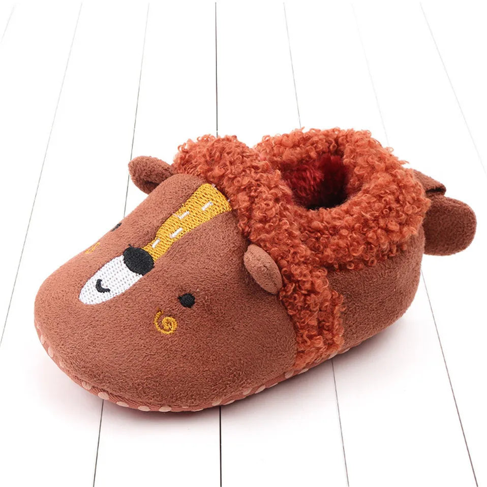 Brown bear baby slipper with a stitched face and fuzzy cuff.