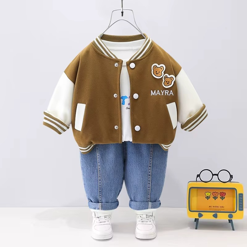 Brown-and-cream bear-patch varsity jacket with a white T-shirt and blue jeans