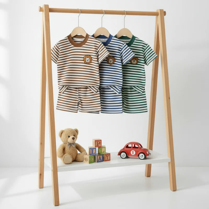 Brown, blue, and green striped T-shirt and shorts sets hanging on a wooden clothing rack.
