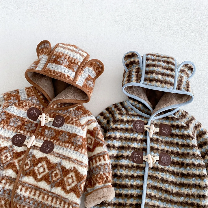 Close-up of brown and blue jacket hoods, contrasting trim, and front toggle closures