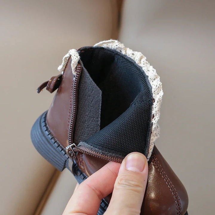 Brown ankle boot with its side zipper open to show the dark interior
