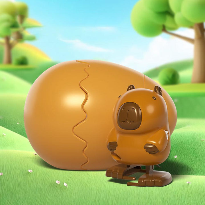 Brown capybara wind-up figure in front of its matching brown egg
