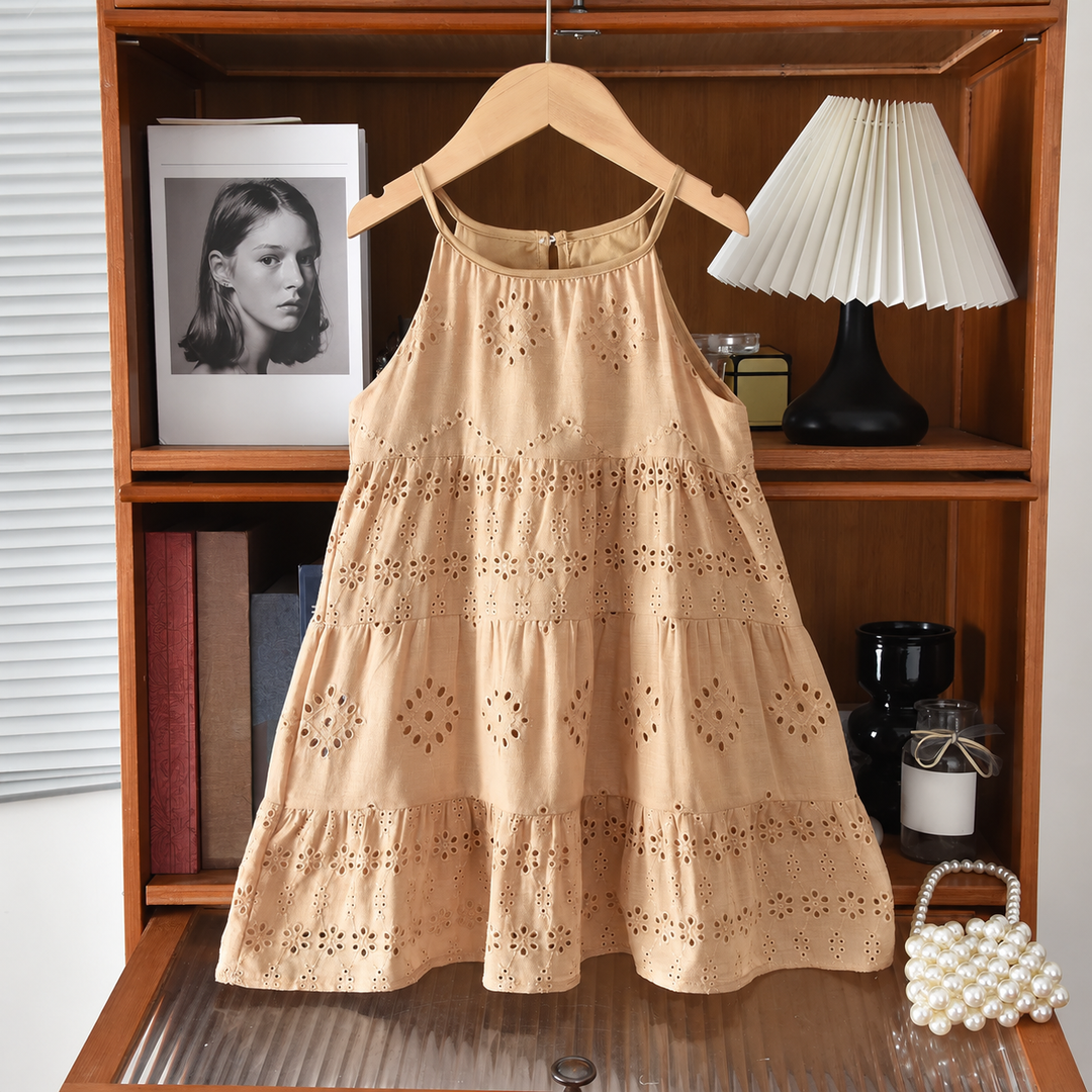 Full view of the brown cotton dress with slim straps and ruffled eyelet tiers