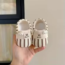 Pair of brown-and-cream striped baby shoes with cream interiors