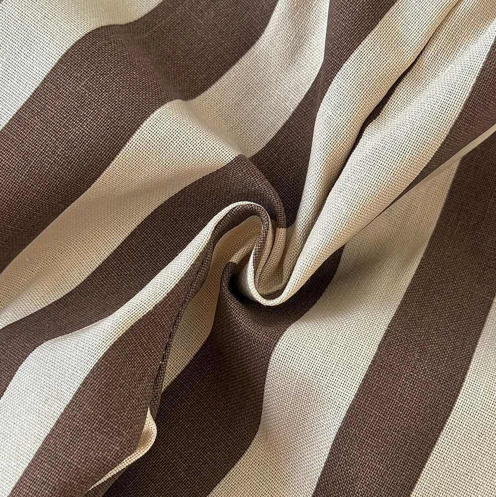 Close-up of brown and cream striped fabric gathered into a fold