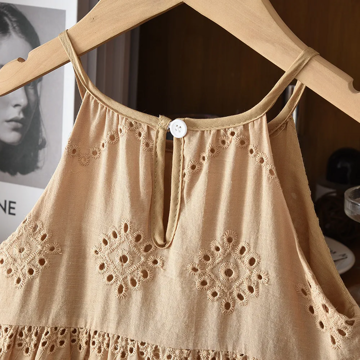Brown dress back neckline with a button closure, keyhole opening and floral eyelet embroidery