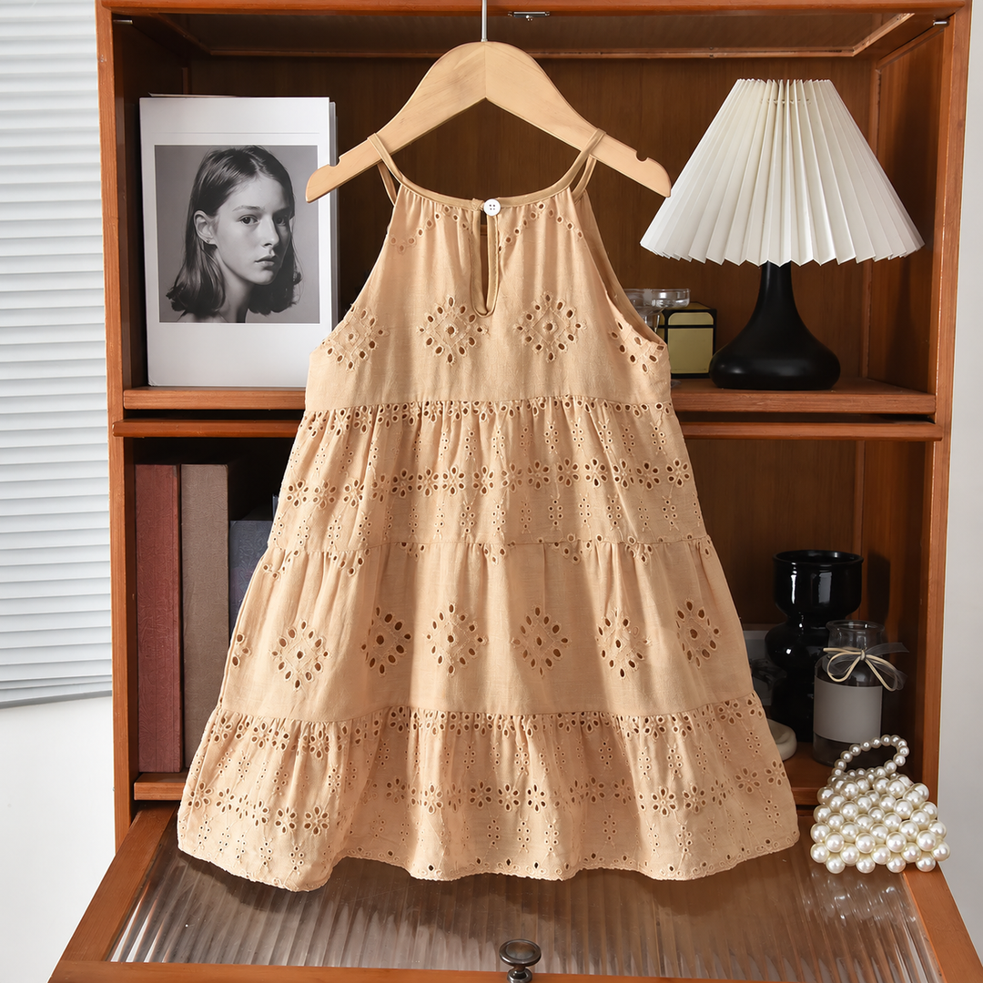 Brown sleeveless eyelet dress on a hanger, showing the full tiered silhouette