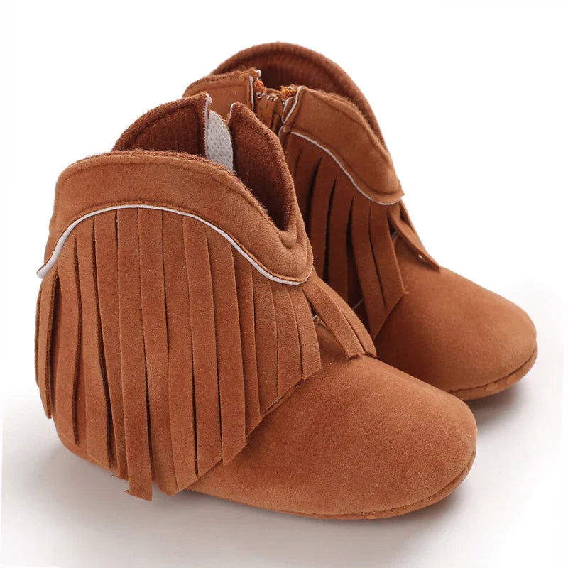 Brown baby cowboy boots with fringe trim and curved ankle openings