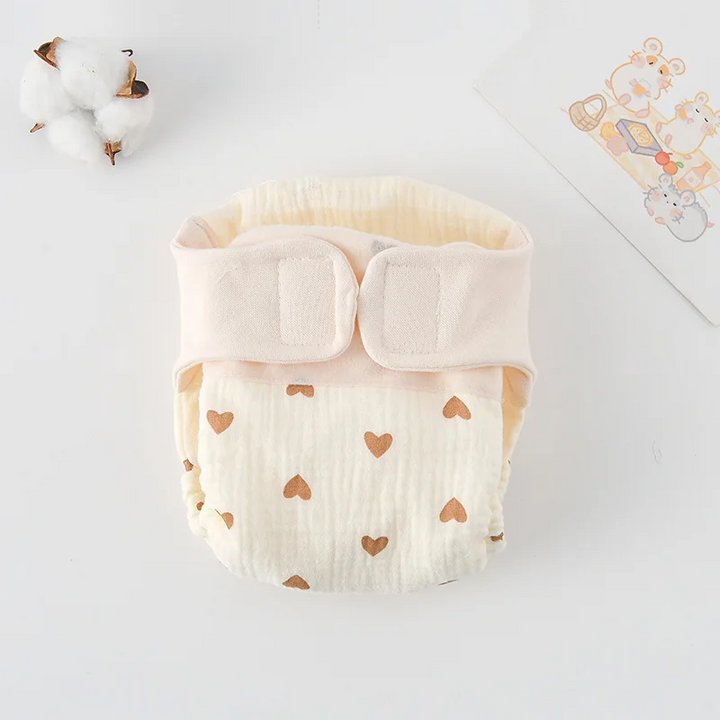 Small brown-heart print cloth diaper with a cream hook-and-loop waistband