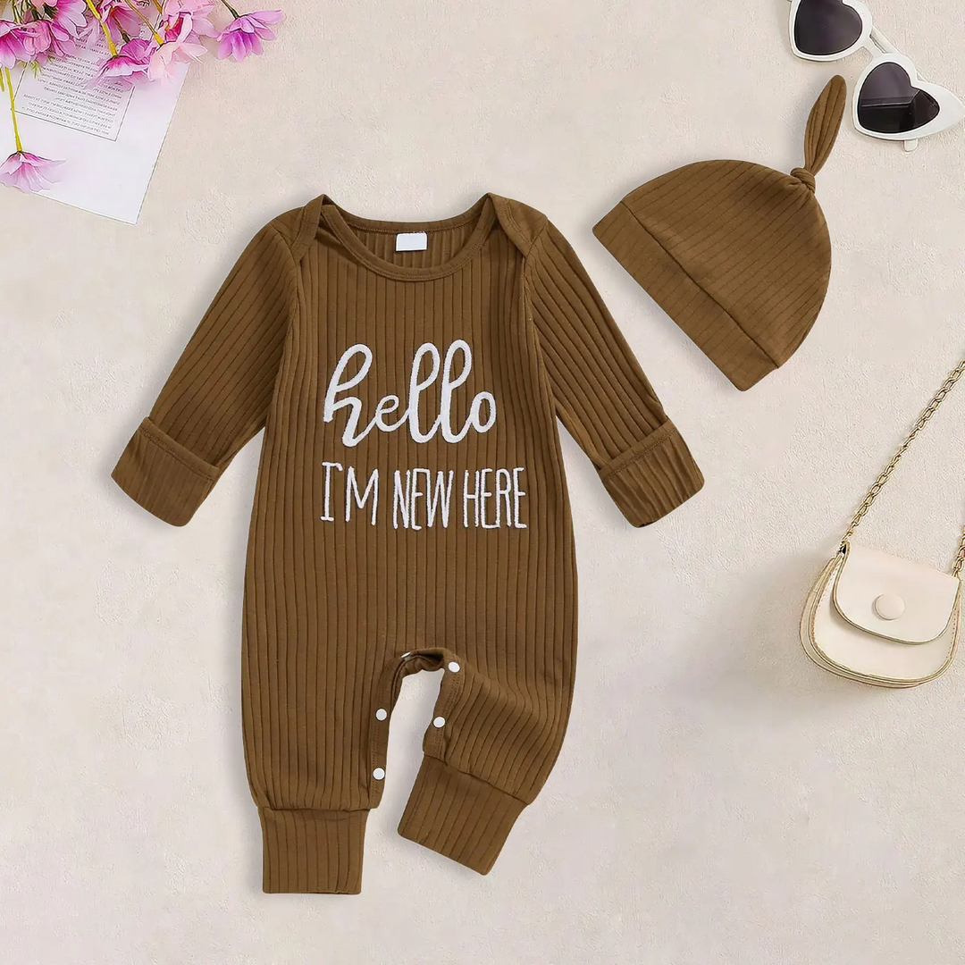 Brown ribbed baby jumpsuit with white hello lettering and a matching knotted beanie