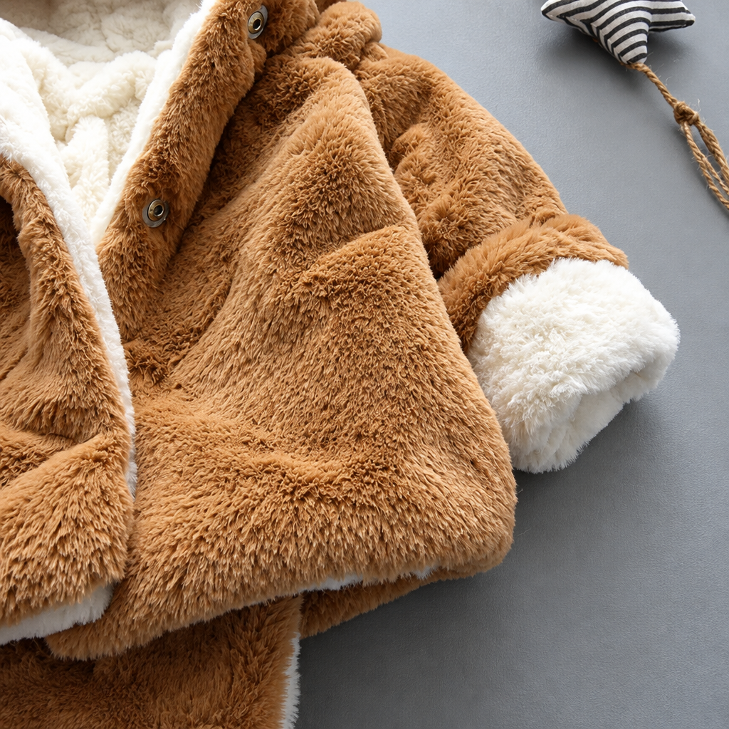 Open brown plush jacket showing front buttons, cream lining and a cream cuff