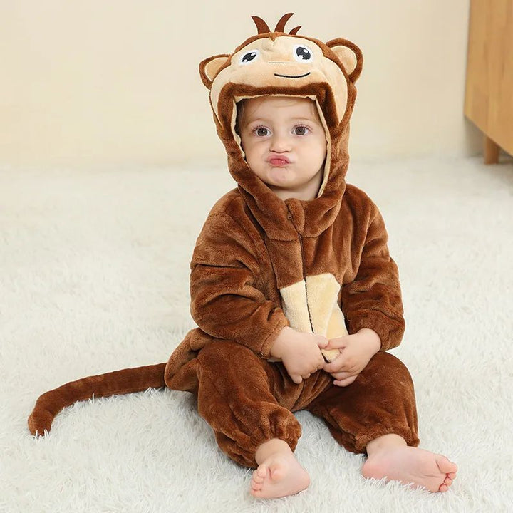 Baby in a brown monkey onesie with a cream belly, monkey-face hood, and tail
