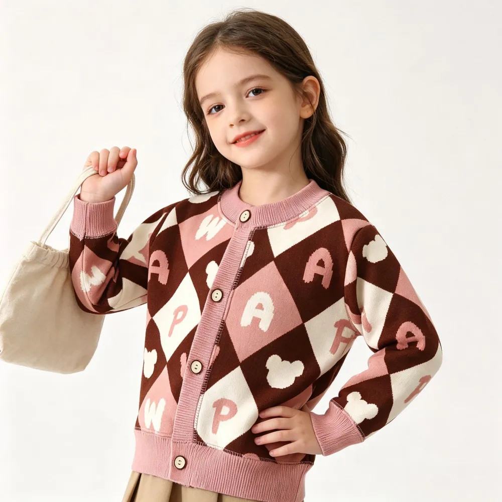 Brown and pink patterned knit cardigan styled with a cream tote bag