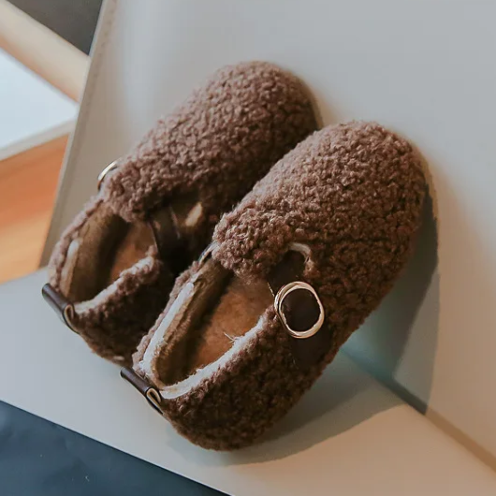 Brown plush winter shoes with rounded toes and side buckle details