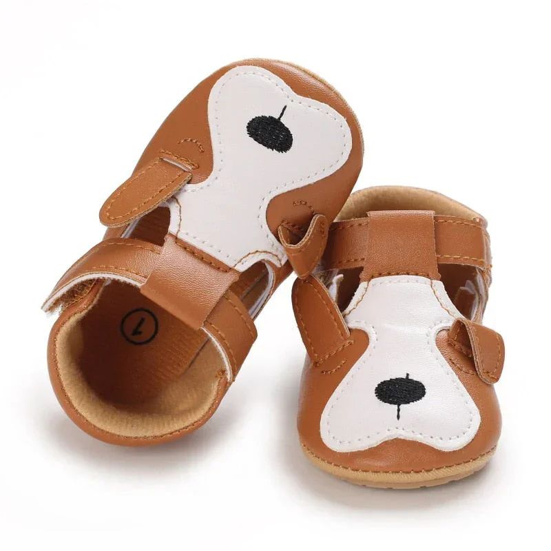 Brown puppy baby shoes with white face panels and floppy ears