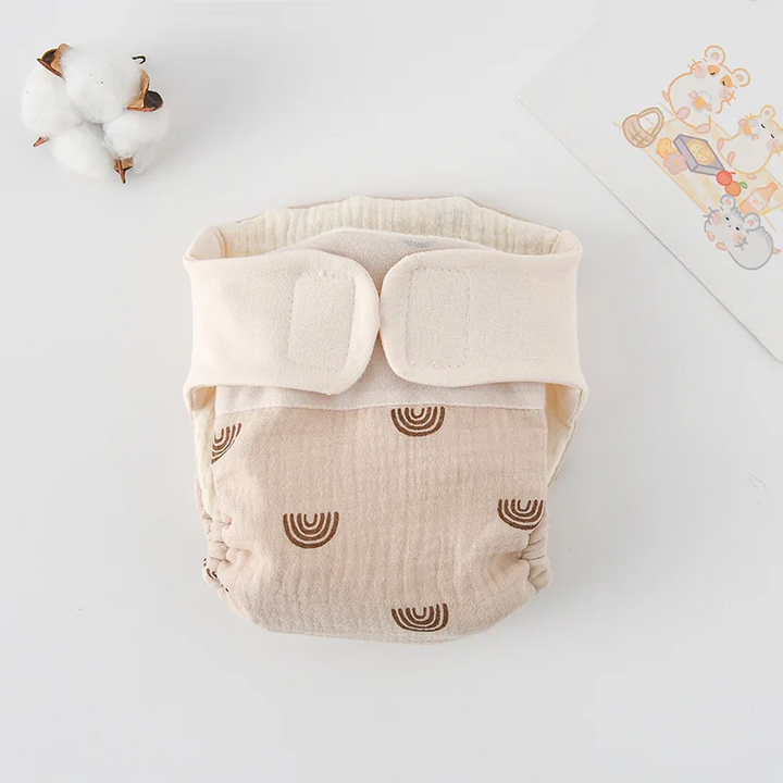 Cloth diaper with brown rainbow prints and a cream hook-and-loop waistband