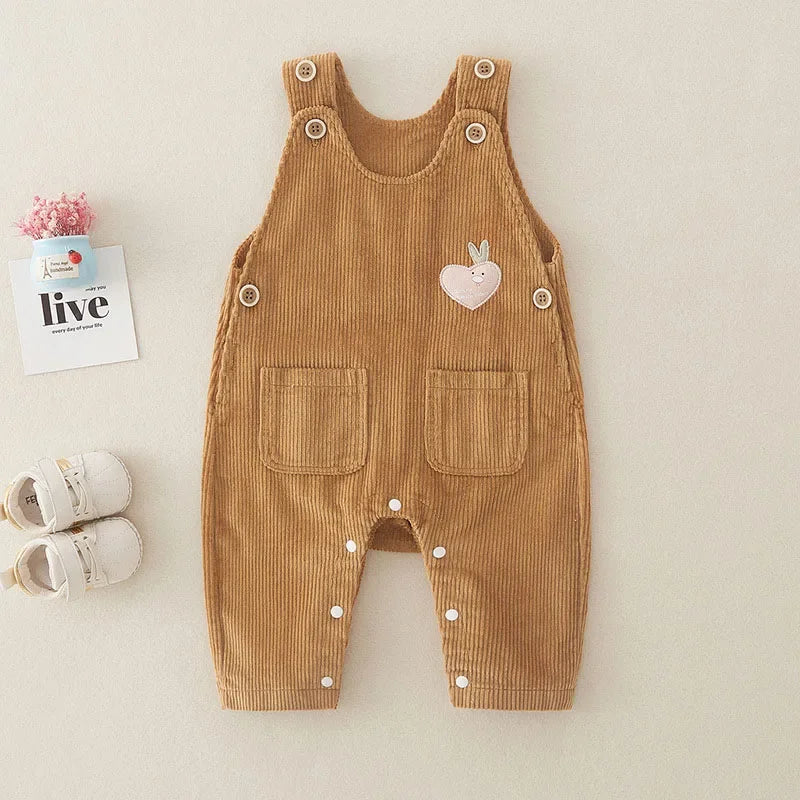 Brown ribbed baby overalls with front pockets, shoulder buttons, and leg snaps