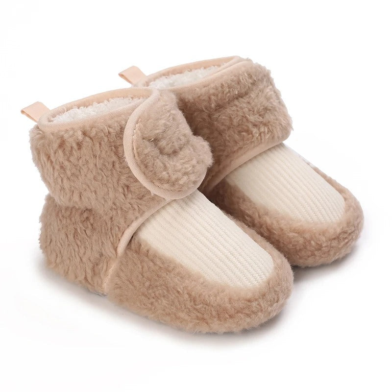 Brown baby shoes with cream ribbed front panels and wraparound ankle straps.