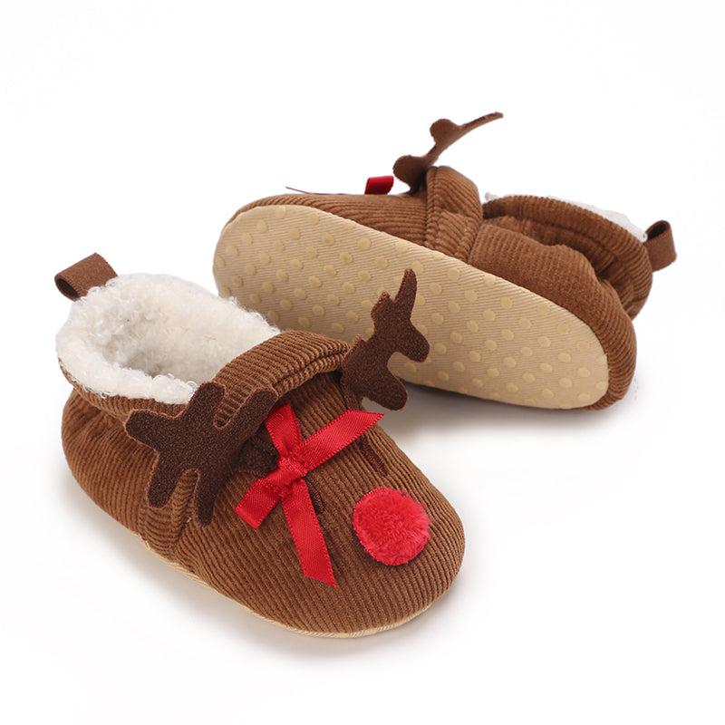 Brown ribbed reindeer baby slippers with red bows, white cuffs and a dotted sole