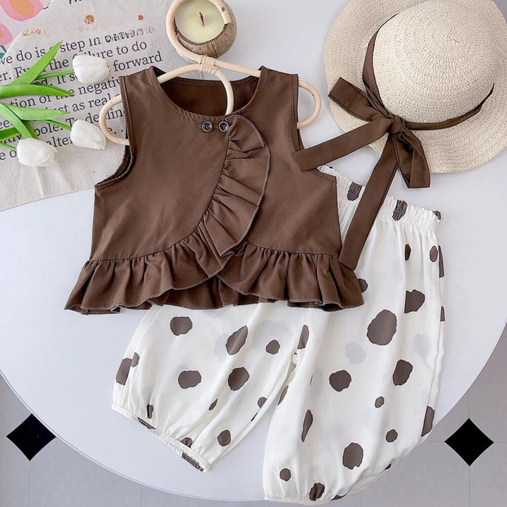 Brown sleeveless ruffle top paired with white bottoms patterned with brown dots