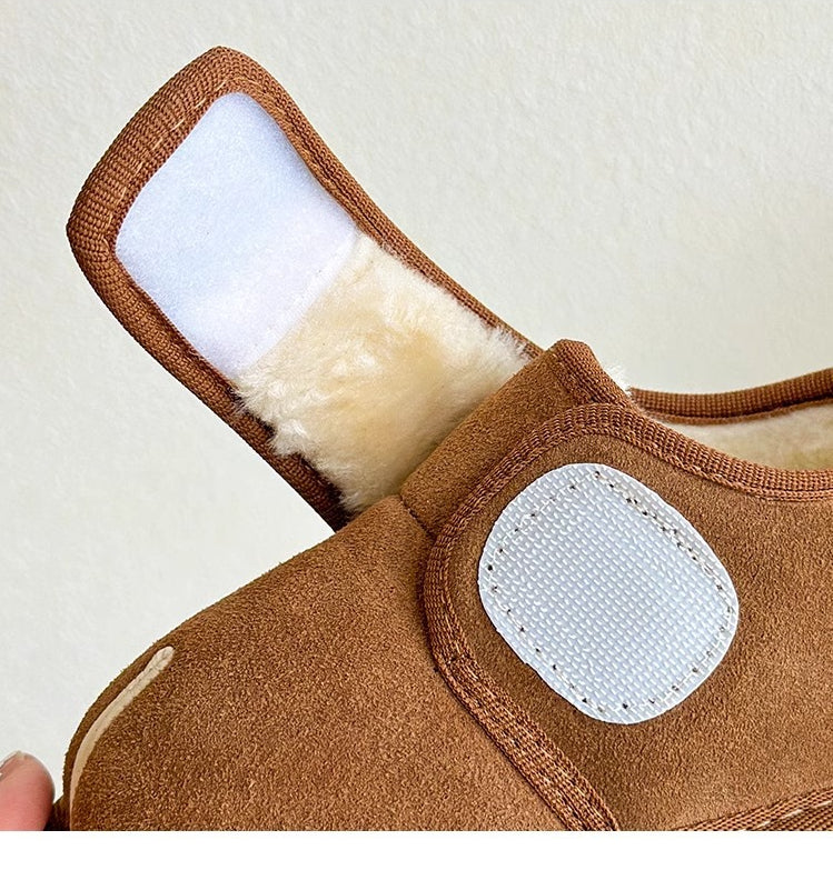 Brown shoe with its wide hook-and-loop strap lifted to reveal the fastening patches.