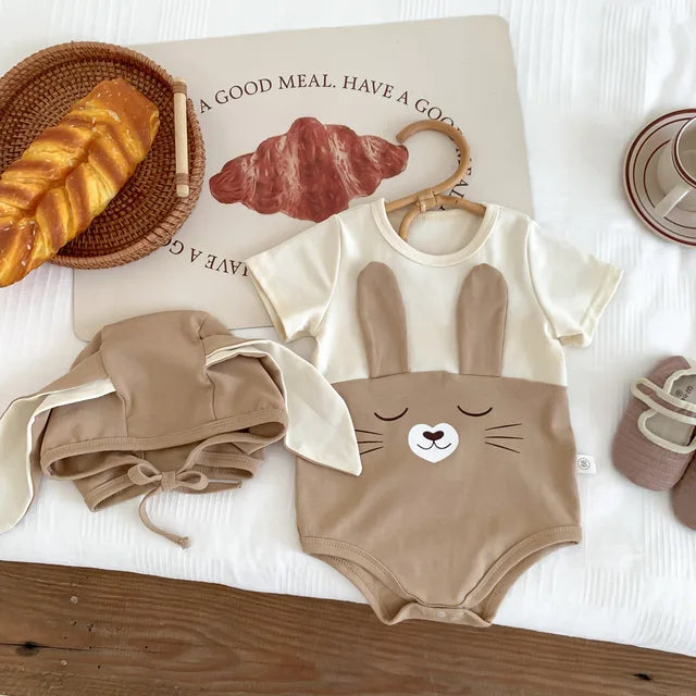 Brown short-sleeve cotton bunny bodysuit beside its matching cap