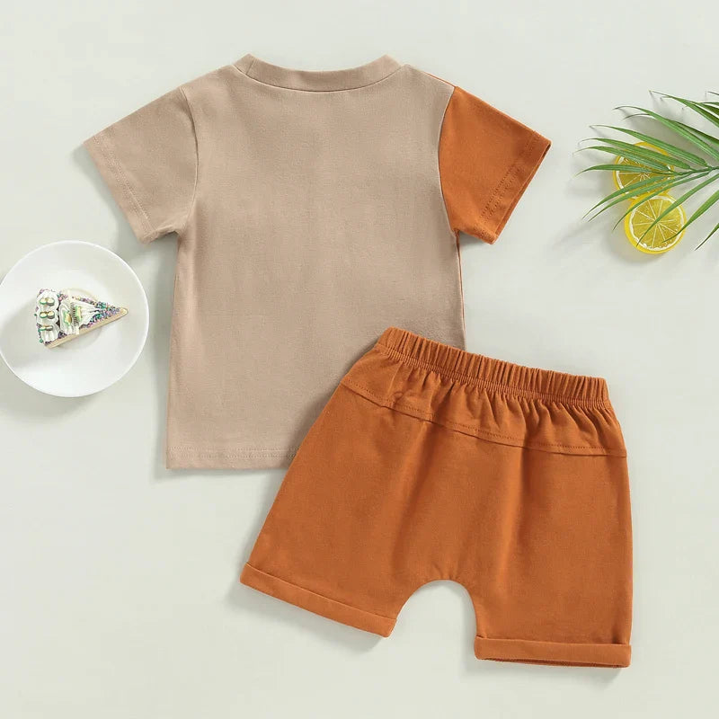 Back of the beige T-shirt with a brown sleeve beside matching brown shorts