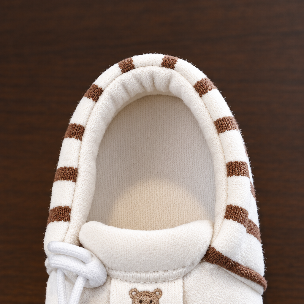 Top view inside a brown striped baby shoe showing the lining and insole