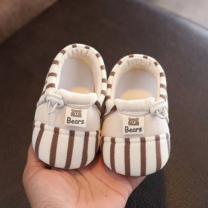 Pair of brown striped baby shoes with elastic closures and bear details