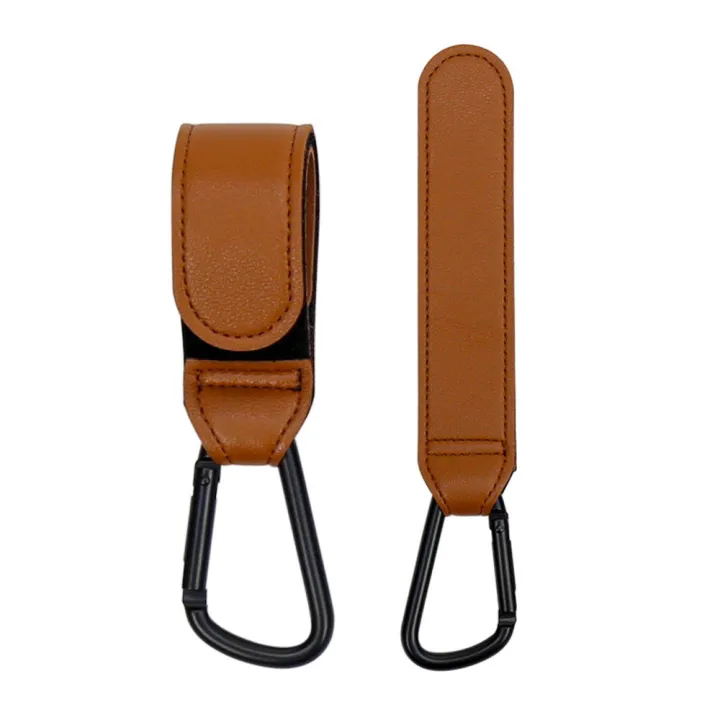 Brown stroller hooks shown with one strap fastened and one extended