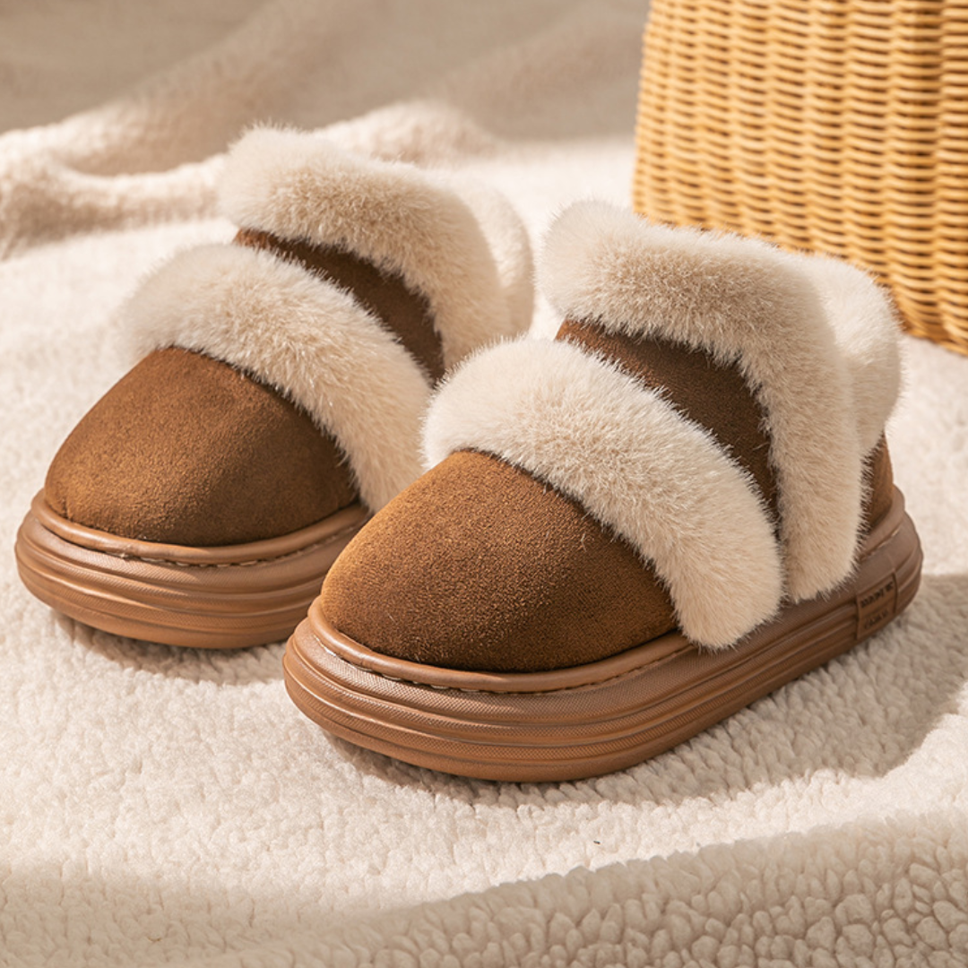 Brown suede ankle boots with cream plush trim on a blanket beside a woven basket.