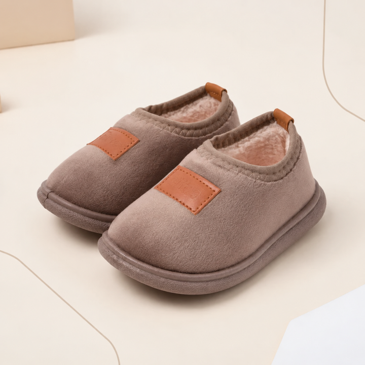 Brown suede winter slippers with tan patches, soft linings, and flat soles