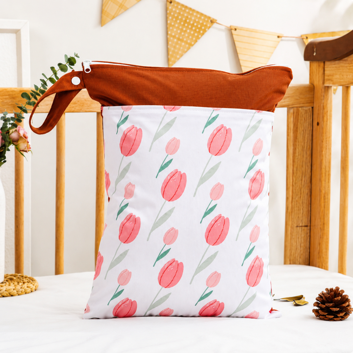 Brown-trim diaper wet bag with pink tulips and a snap loop