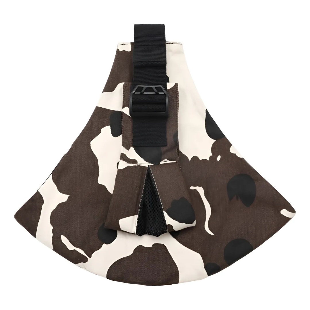 Brown-and-white cow-print hip carrier with a black buckle and shoulder strap