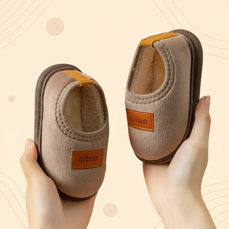 Brown slip-on winter slippers with matching soles, tan patches, and heel loops