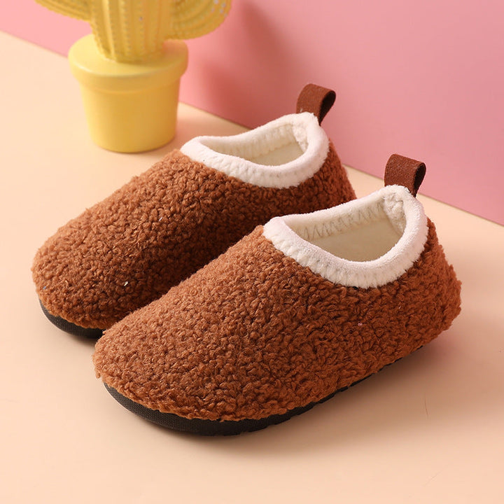 Brown wool slippers with textured uppers, cream-colored lining, and black rubber soles