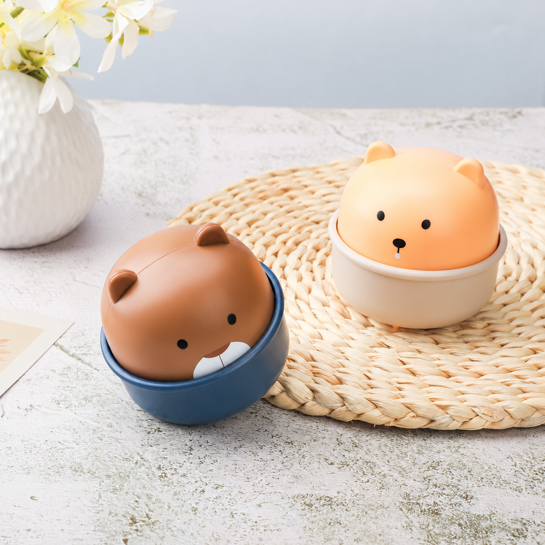 Brown and yellow animal toy cars with cup-shaped bases on a tabletop
