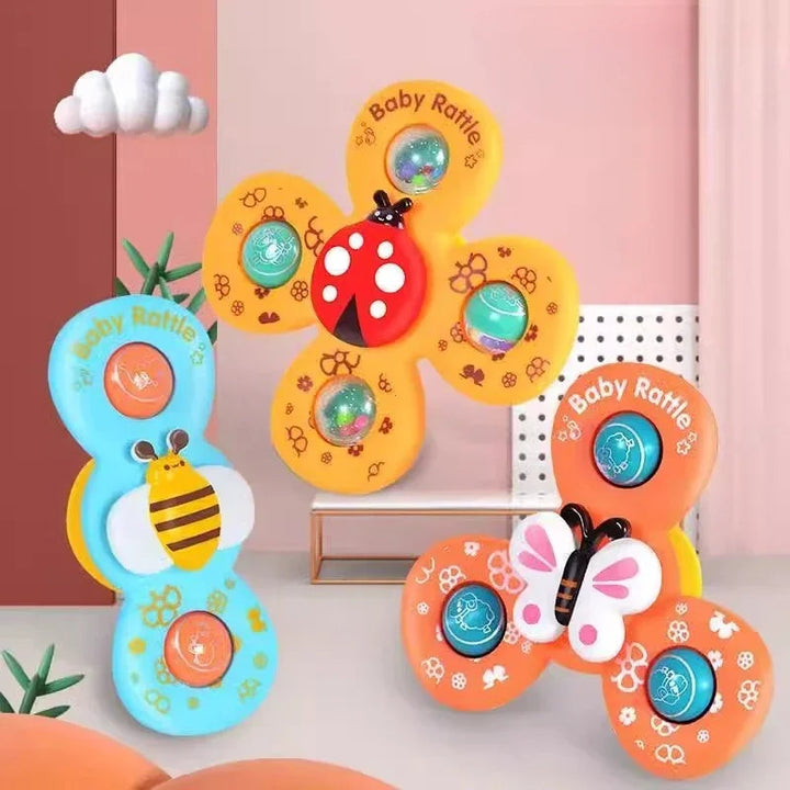Three insect-themed bath spinners in blue, orange, and yellow with bee, butterfly, and ladybug centers.