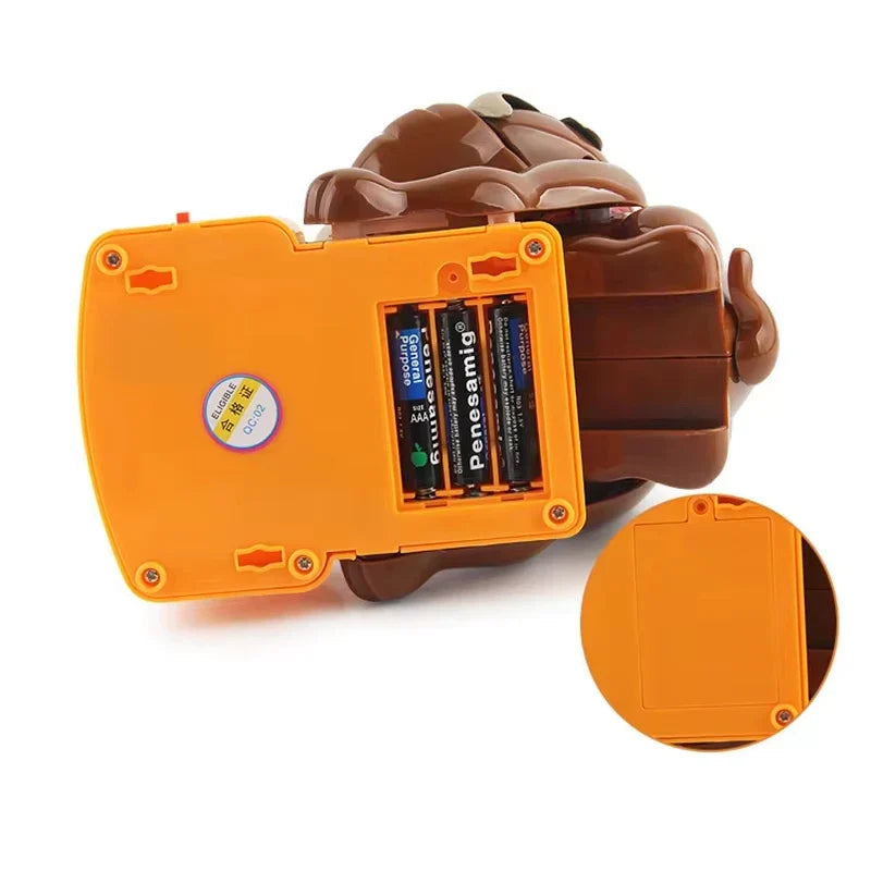 Underside of the orange game base showing the battery compartment and cover