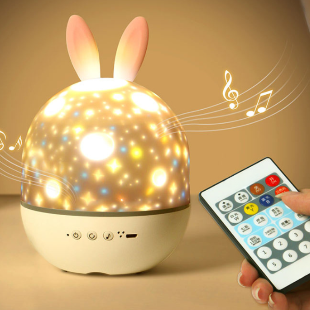 Bunny-ear star projector glowing beside its remote control