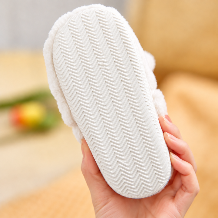 Underside of a bunny slipper showing the herringbone-patterned outsole